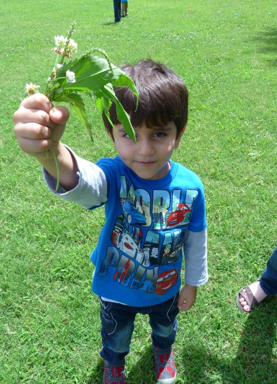 refugee boy with flowers